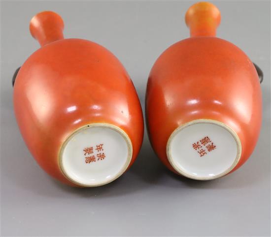 A pair of Chinese coral ground bottle vases, Hongxian mark, Republic period, H. 14cm, wood stands, hairline crack to one vase